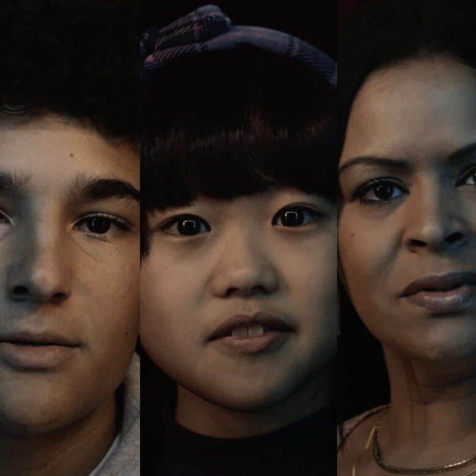 A close-up portrait featuring three individuals facing the camera.