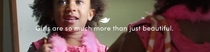 Still from video. Girl looking in a mirror. Text overlay says Girls are so much more than just beautiful.