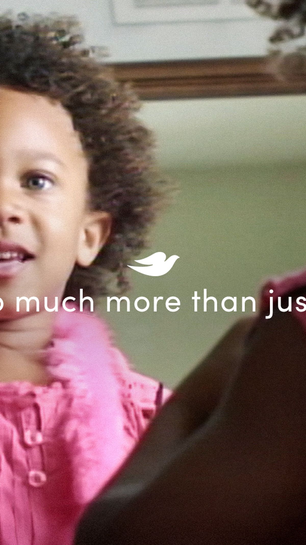 Still from video. Girl looking in a mirror. Text overlay says Girls are so much more than just beautiful.