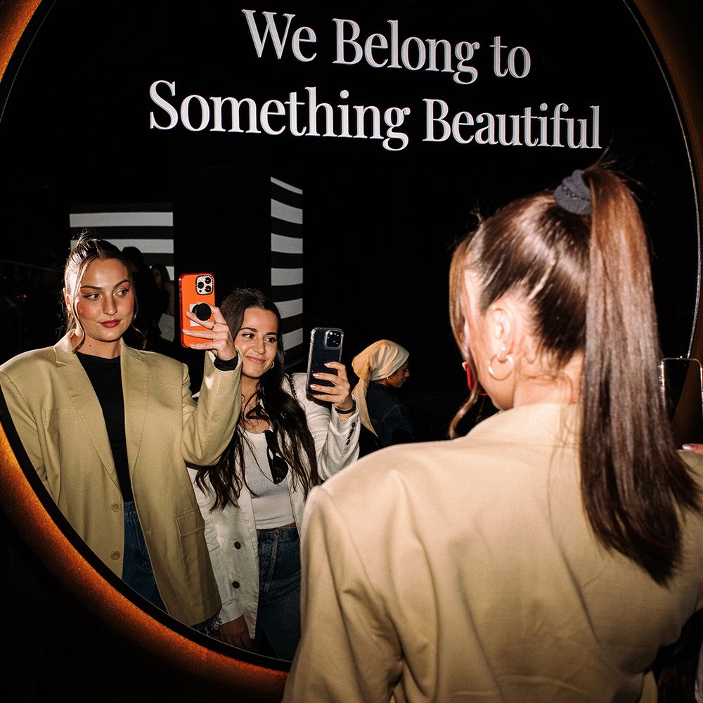 Two women taking a selfie in a mirror.