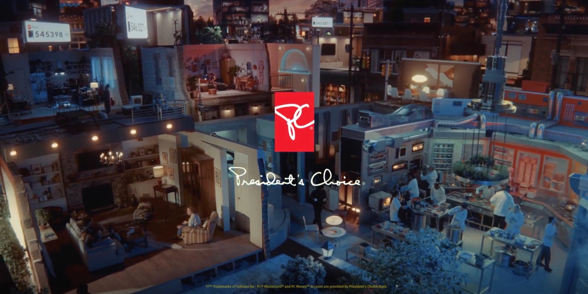 A vibrant, miniature cityscape with dollhouse-like rooms shows people cooking, dining, and socializing. The President’s Choice logo is prominently displayed.