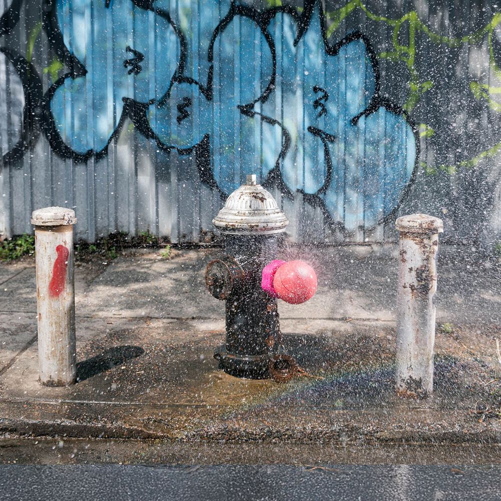 Hydrant attachment spraying water on the street