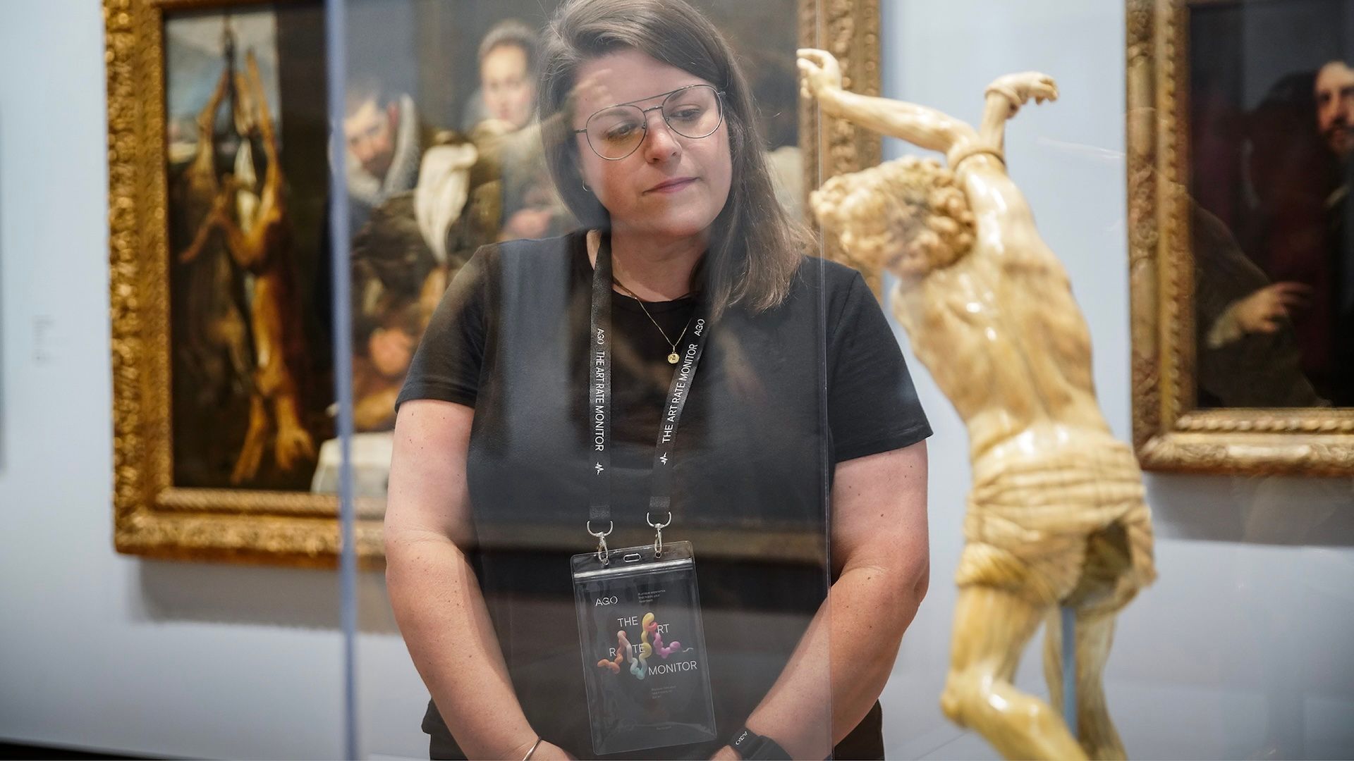 Woman looking at small statue in the Art Rate Monitor exhibit at the AGO