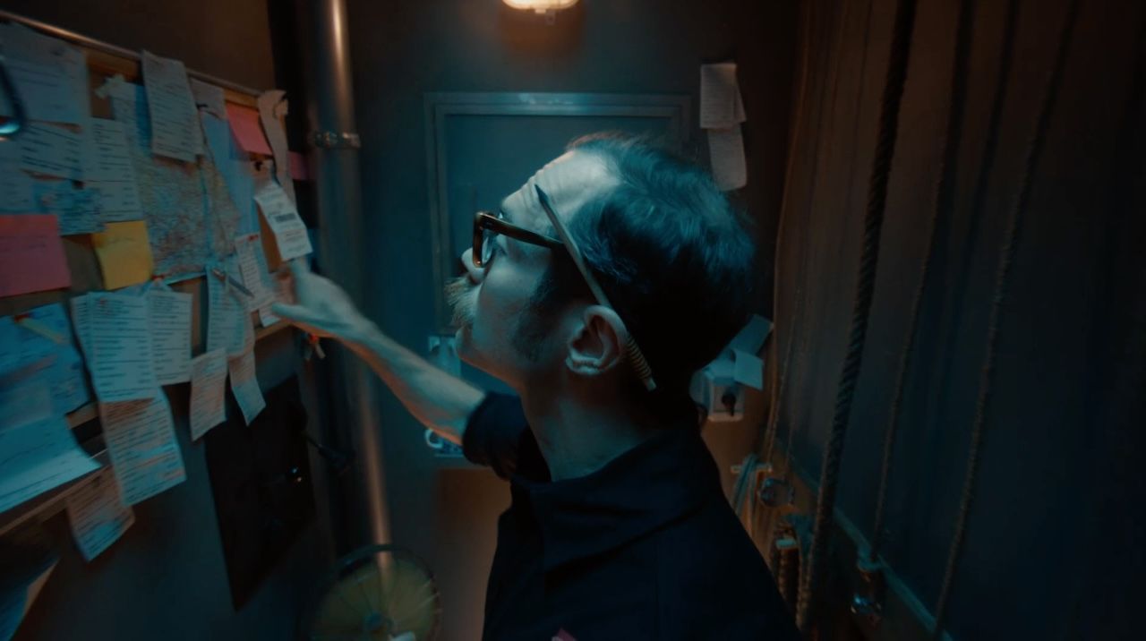 A man looking at a bulletin board filled with notes