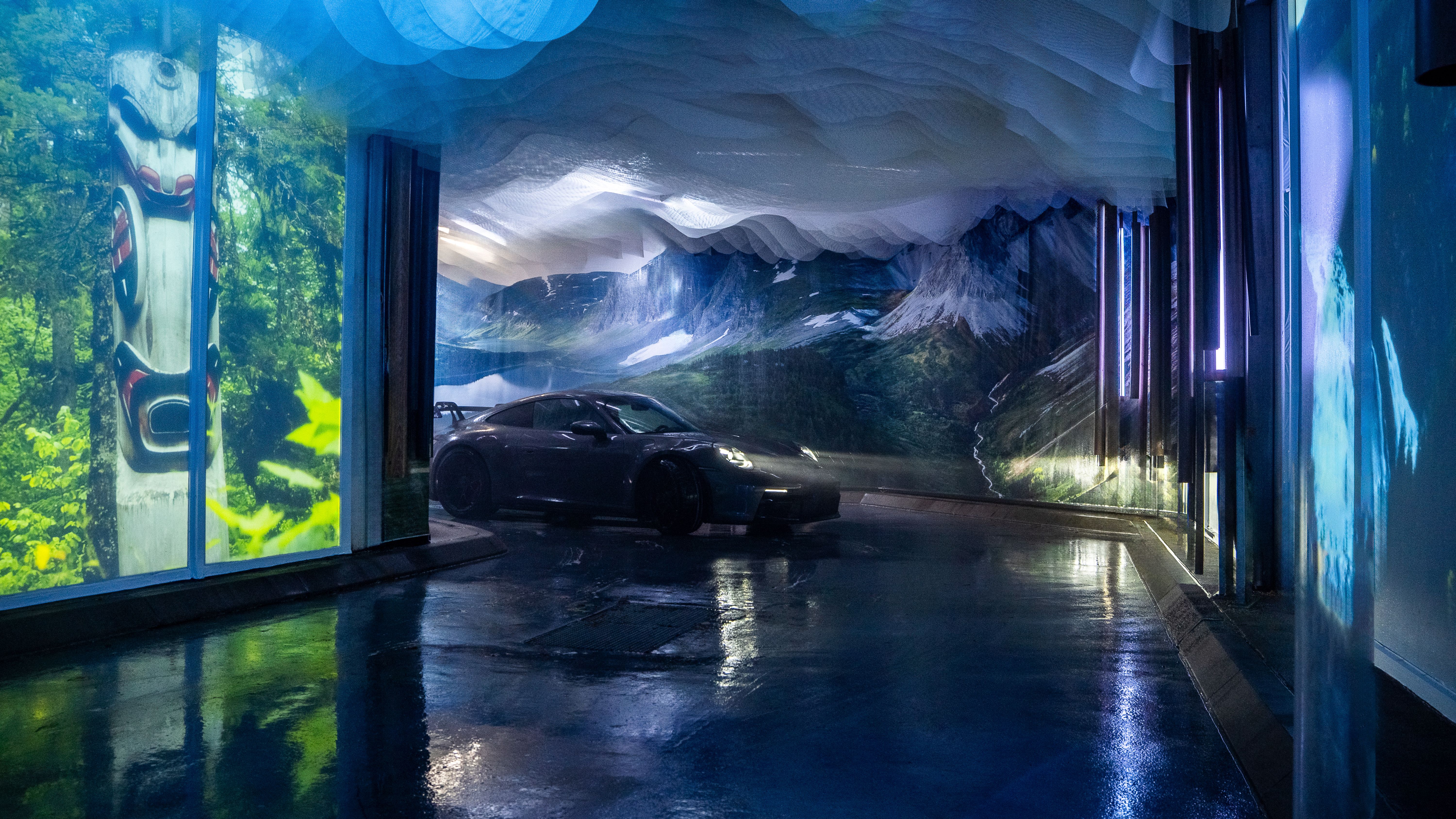 A car driving into a carwash that has been transformed into an immersive, interactive experience showcasing beautiful imagery from British Columbia.