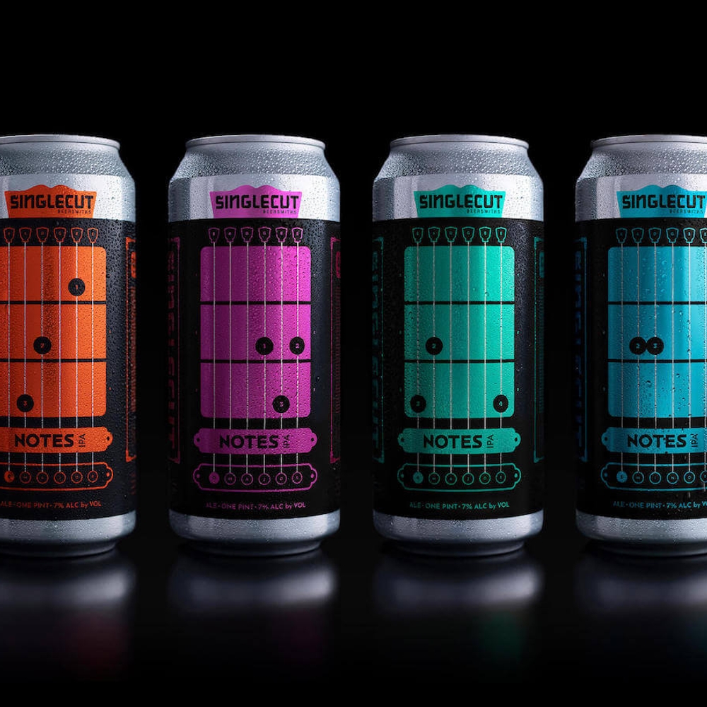 Four Notes IPA cans displayed against a black background, each featuring basic chords and finger positions.