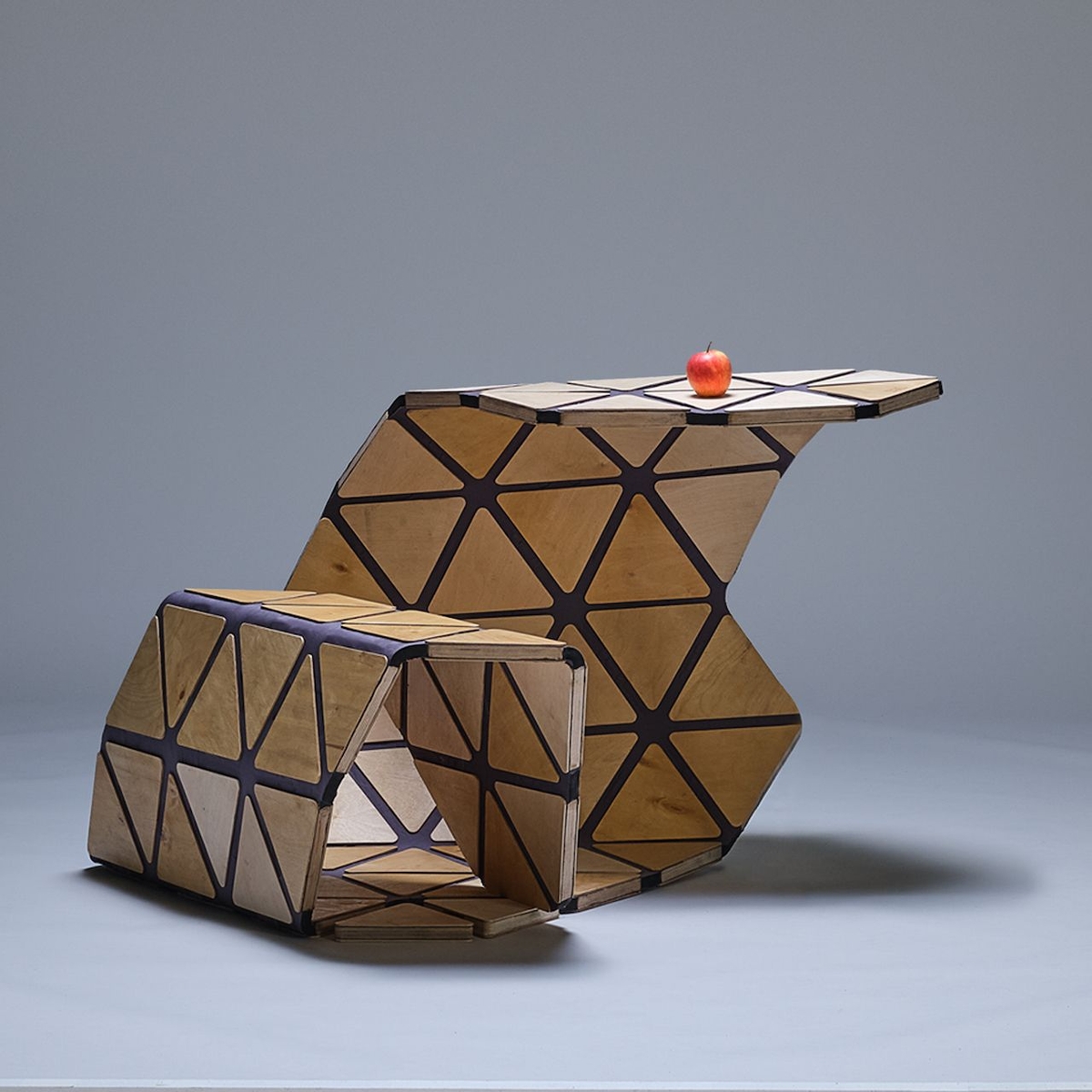 Multi-functional Unstandardized desk constructed as a single adaptable piece, currently configured as both a seating area and a desk.