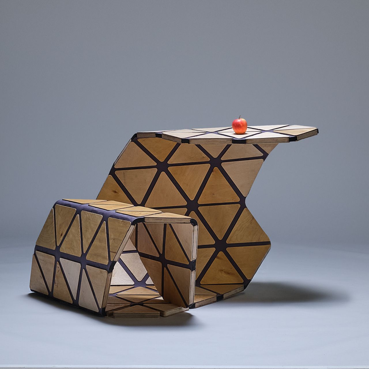 Multi-functional Unstandardized desk constructed as a single adaptable piece, currently configured as both a seating area and a desk.