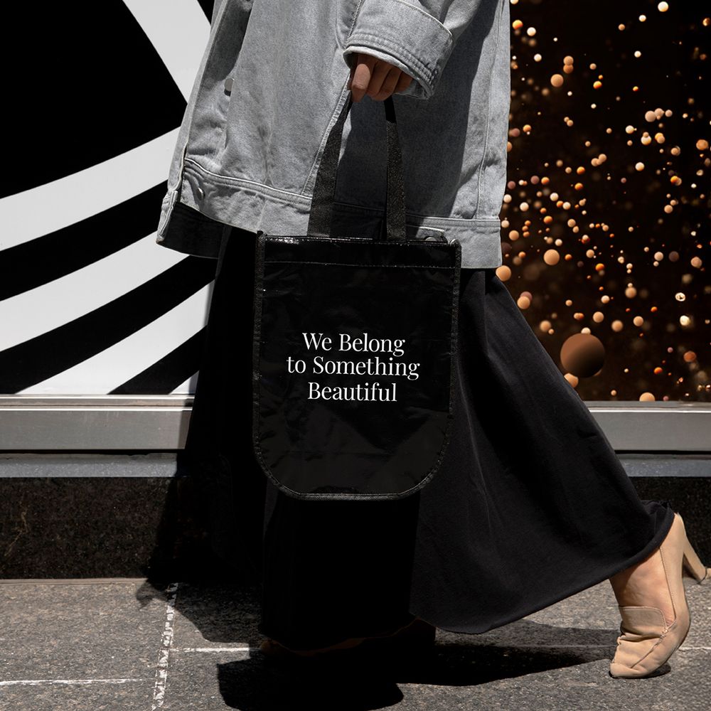 A women holding a Sephora bag that reads We Belong To Something Beautiful