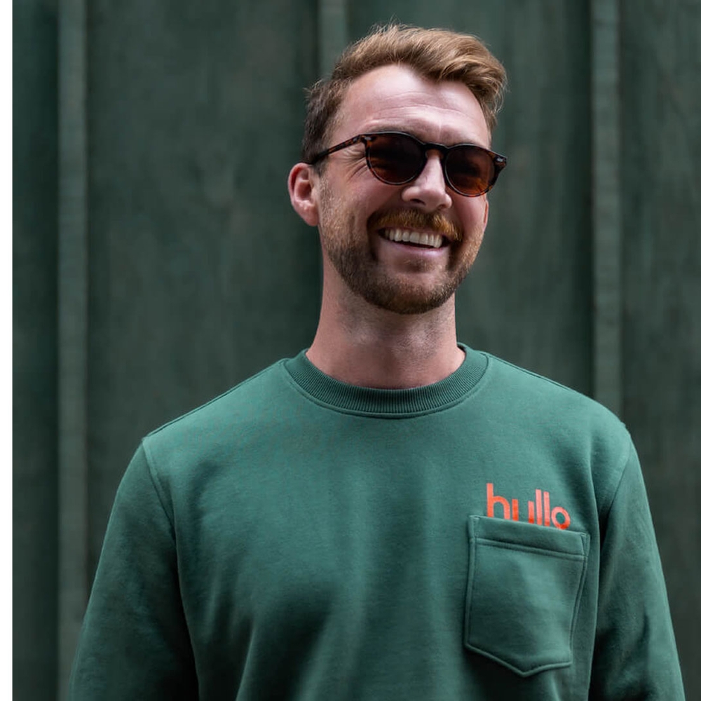 Man wearing hullo sweater.