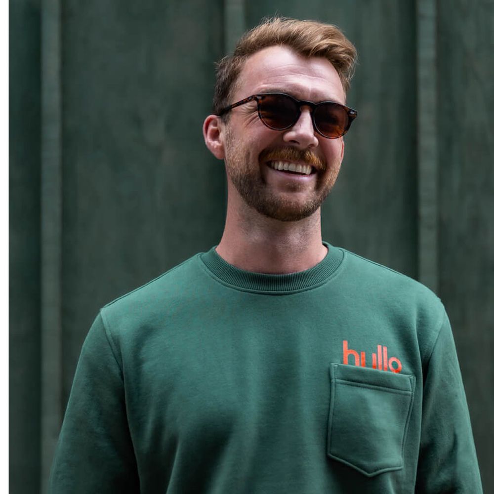 Man wearing hullo sweater.