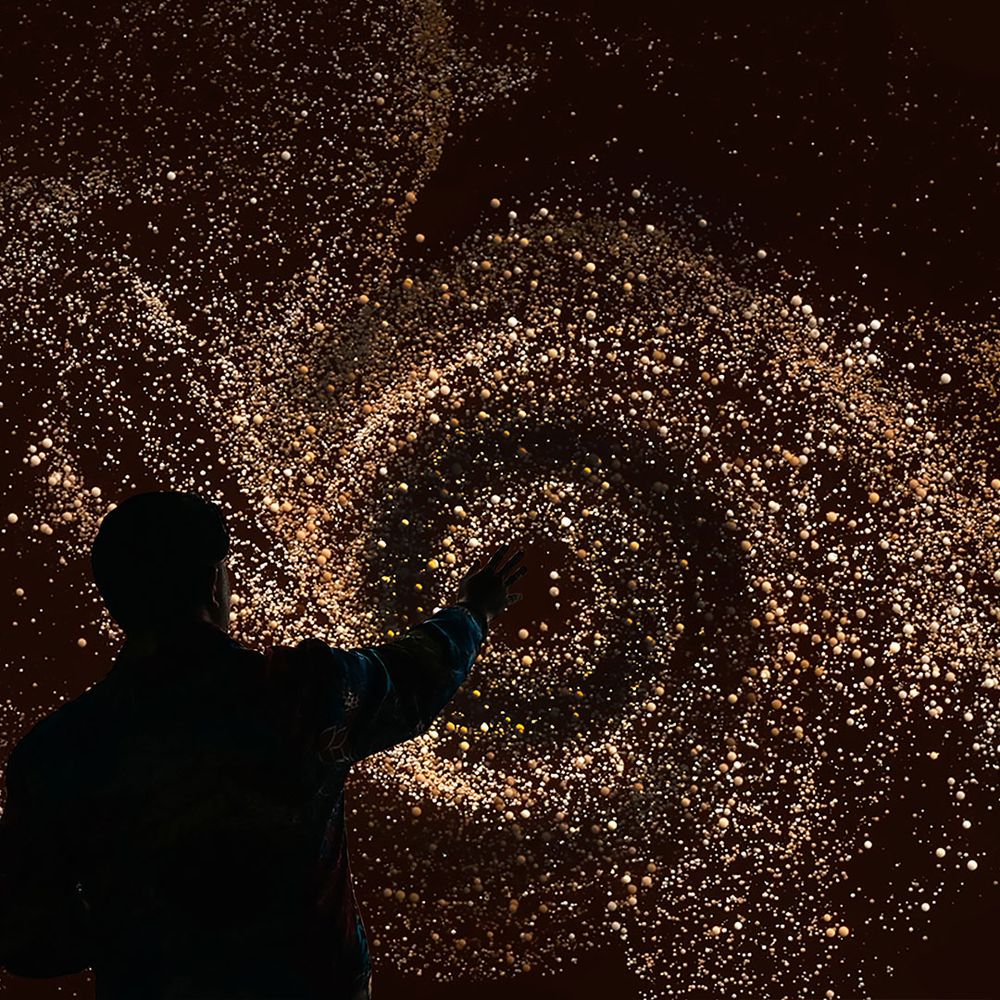 A man interacting with an immersive art exhibit.