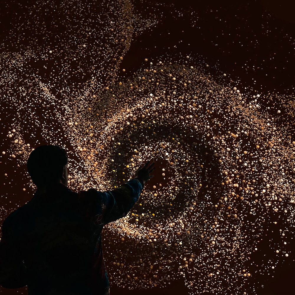 A man interacting with an immersive art exhibit.