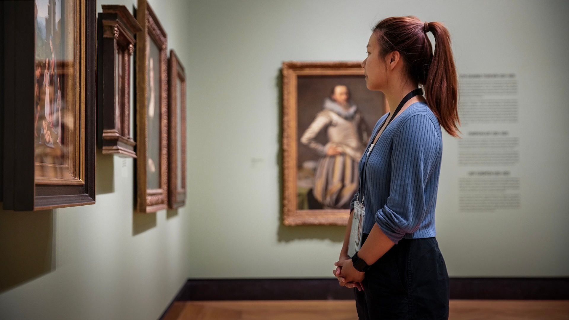 Woman looking at artwork in the Art Rate Monitor exhibit at AGO.