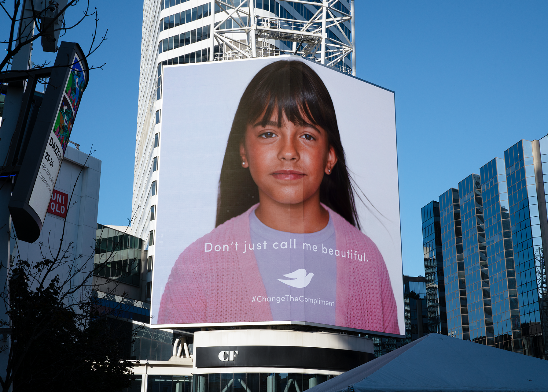 Outdoor billboard displaying a young girl’s portrait with the text