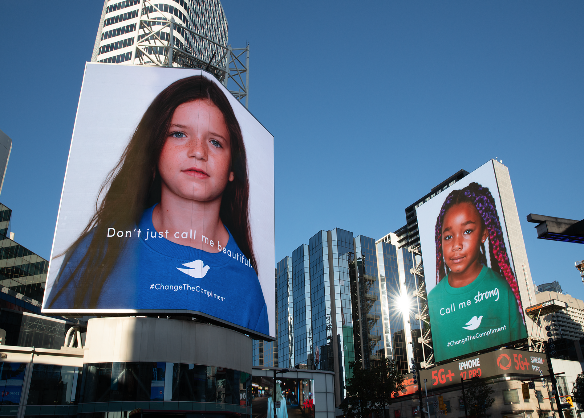 Outdoor billboard displaying young girls portrait with the text