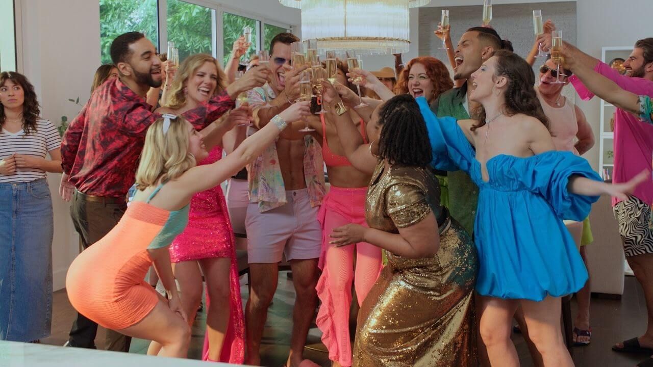 A group of attractive young people raising champagne glasses while celebrating.