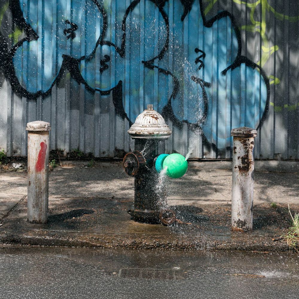 Hydrant attachment spraying water on the street