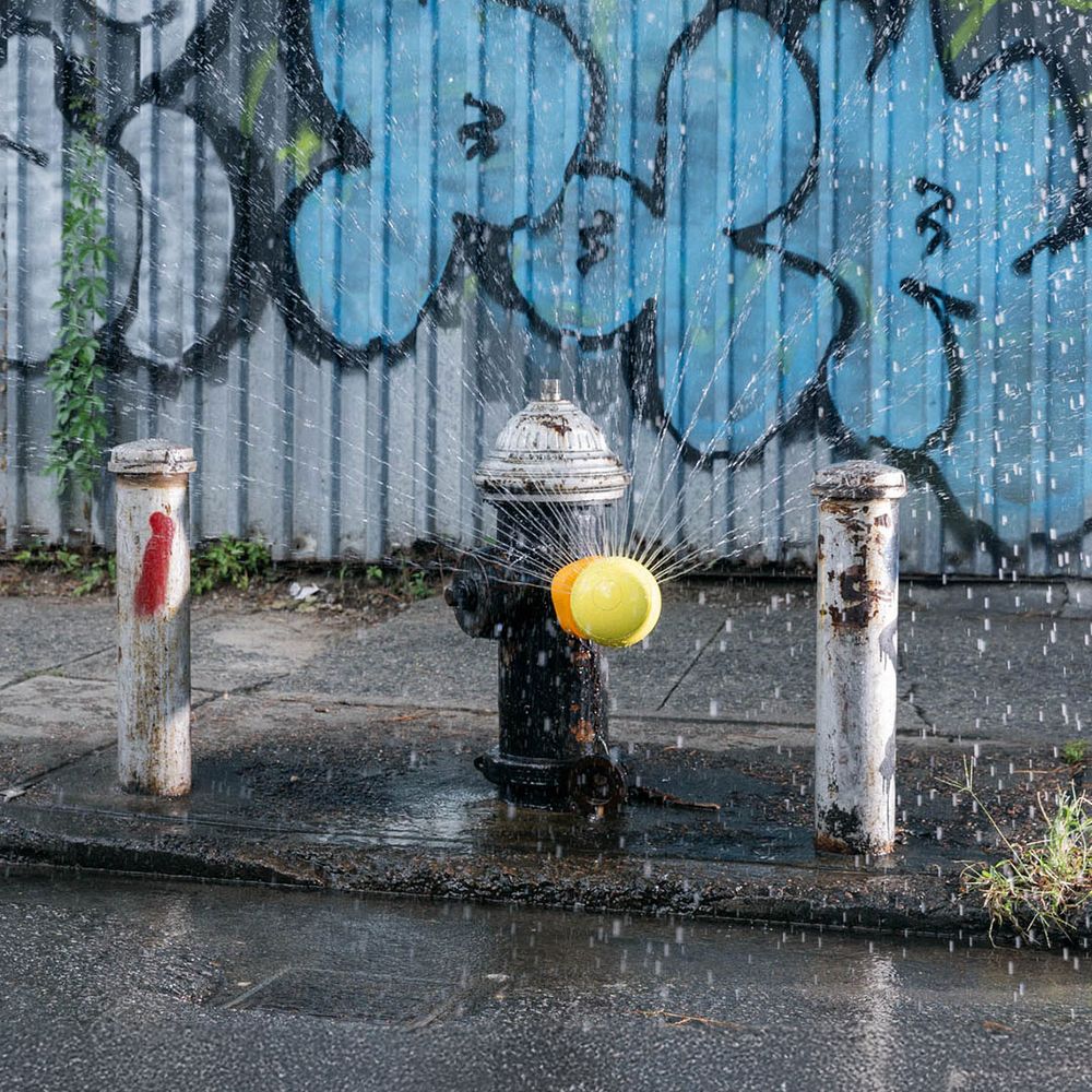 Hydrant attachment spraying water on the street