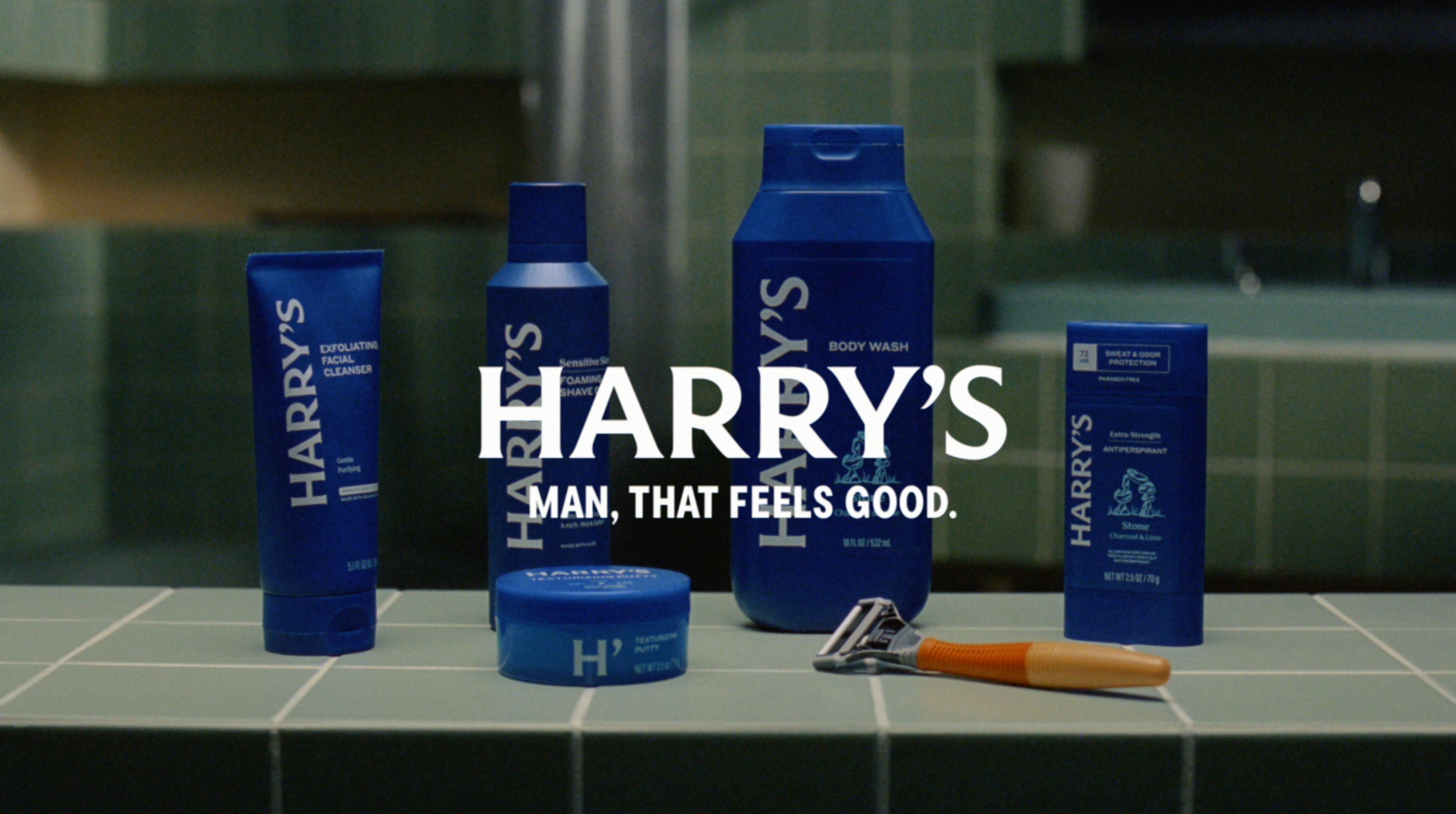 Harry's portfolio of grooming products sit in a bathroom with a logo and tagline on top.