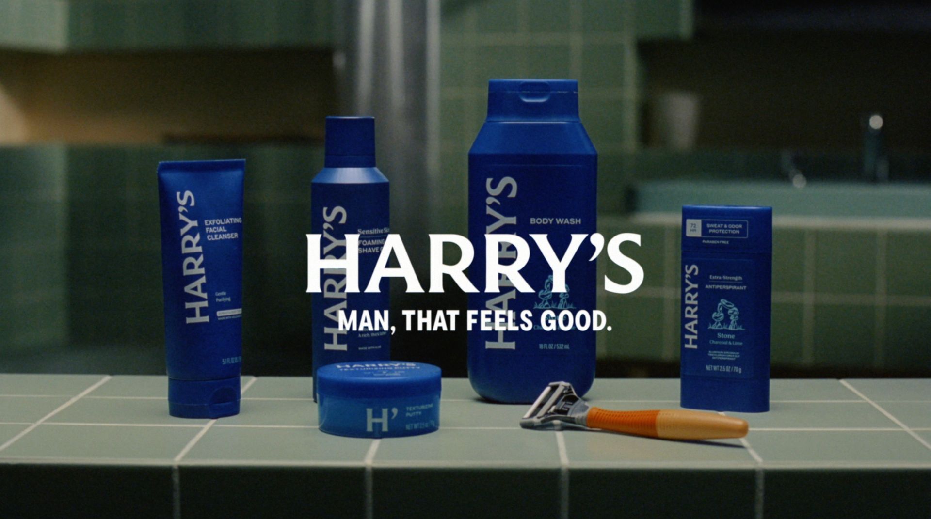 Harry’s portfolio of grooming products sit in a bathroom with a logo and tagline on top.