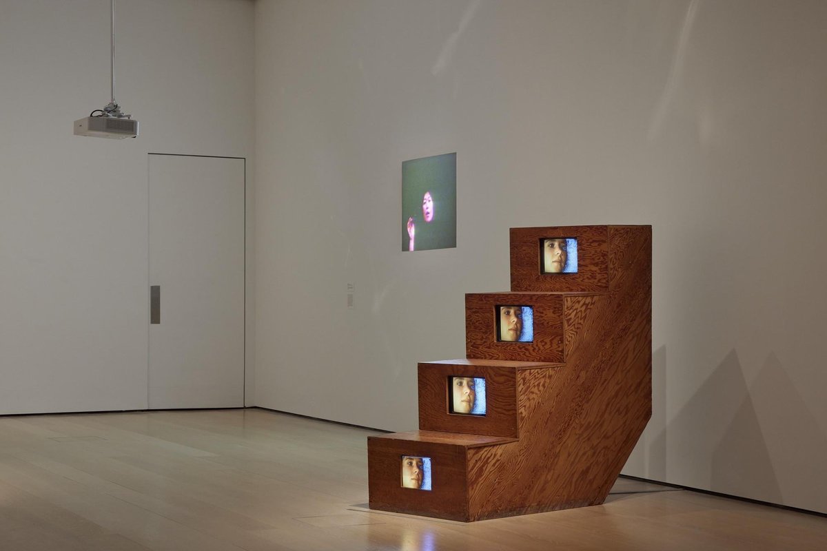Projection sculpture with faces on stair monitors