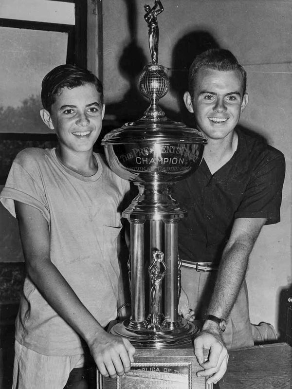 Addington with his caddy championship trophy and younger brother