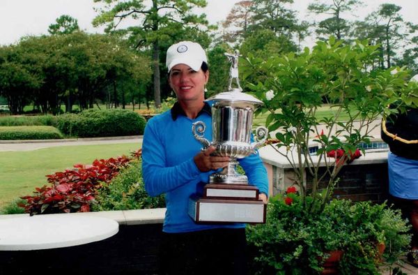 Robin Burke hoisting the Houston Women’s City Amateur Championship trophy