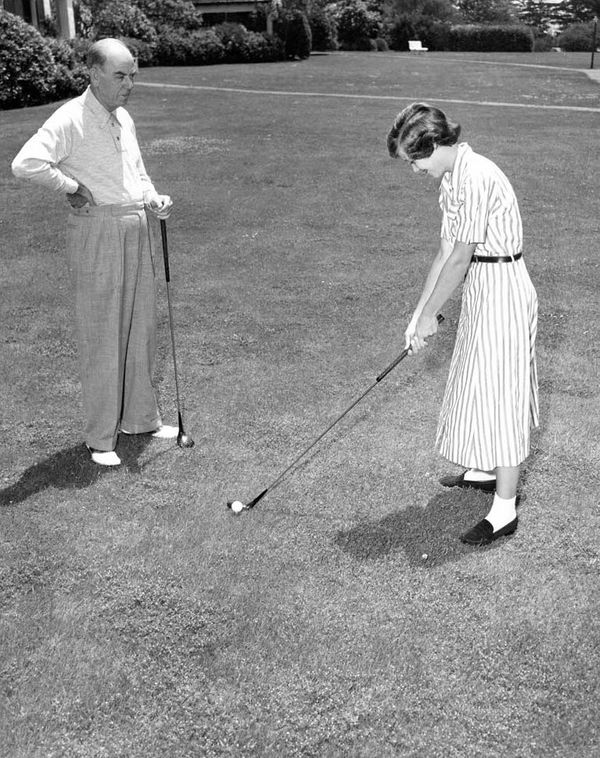 Marvin giving young Marty a golf lesson
