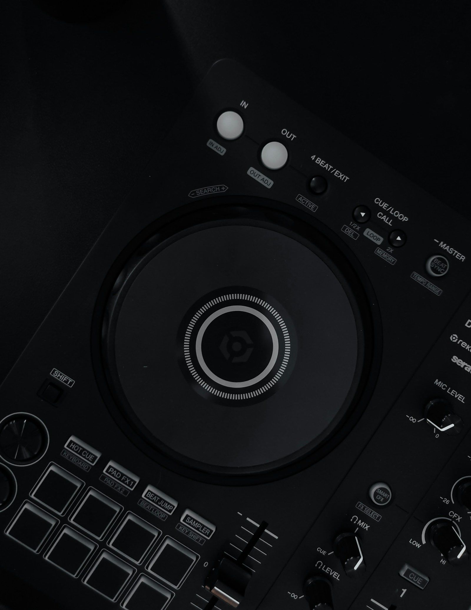 Top-down view of a Pioneer DDJ-FLX4 DJ controller on a dark surface with USB-C cable
