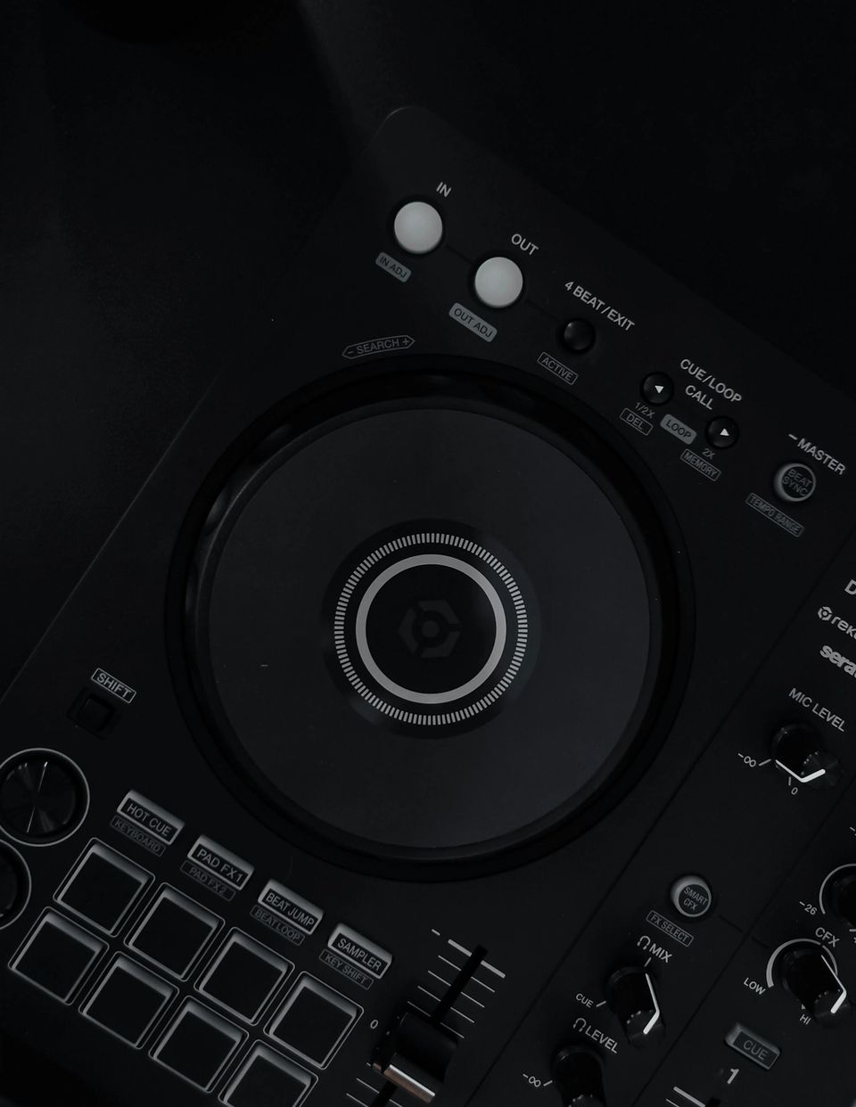 Top-down view of a Pioneer DDJ-FLX4 DJ controller on a dark surface with USB-C cable