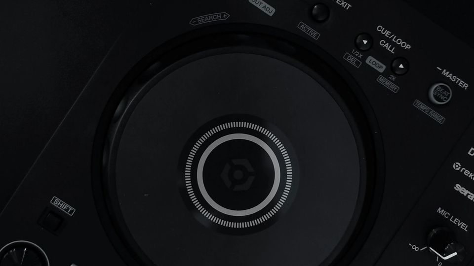 Top-down view of a Pioneer DDJ-FLX4 DJ controller on a dark surface with USB-C cable