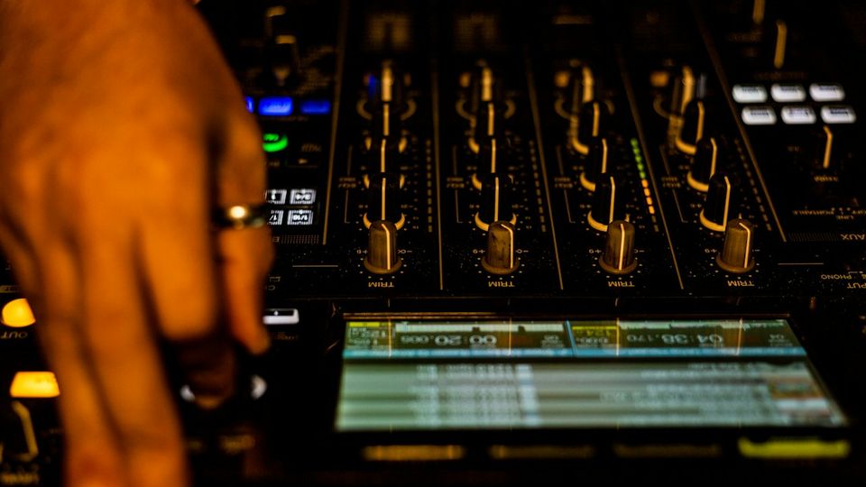 Pioneer CDJ decks and mixer in a DJ booth during a performance