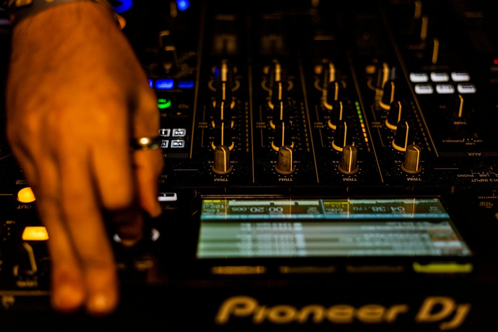Hand on Pioneer DJM mixer faders