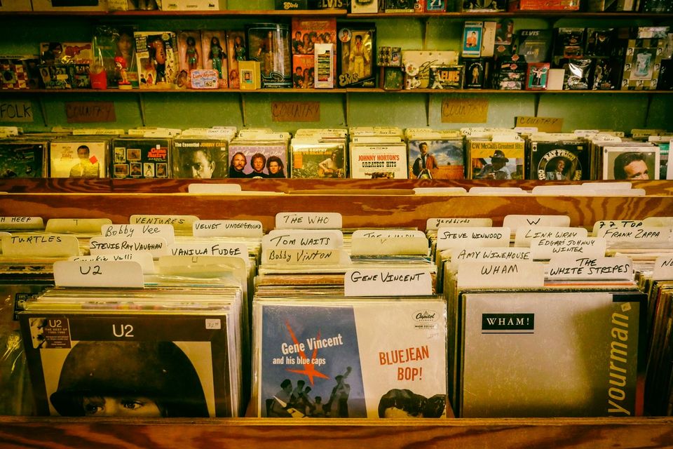 Record store shelves stocked with vinyl and CDs
