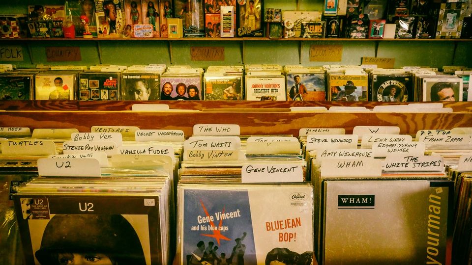 Record store shelves stocked with vinyl and CDs