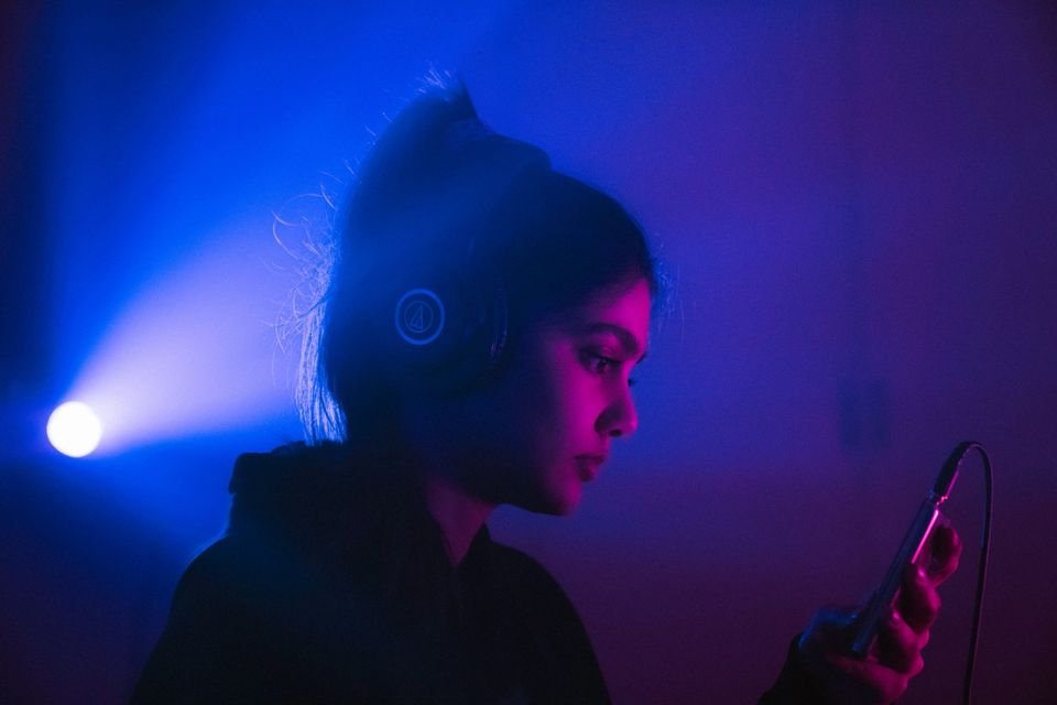 DJ with headphones at a venue