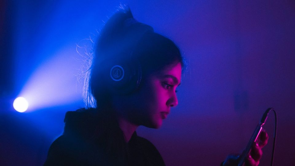 DJ with headphones at a venue