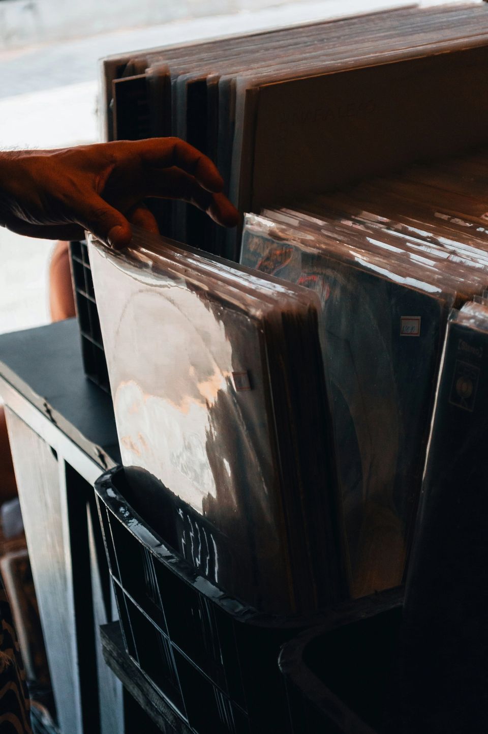 Hand flipping through vinyl records