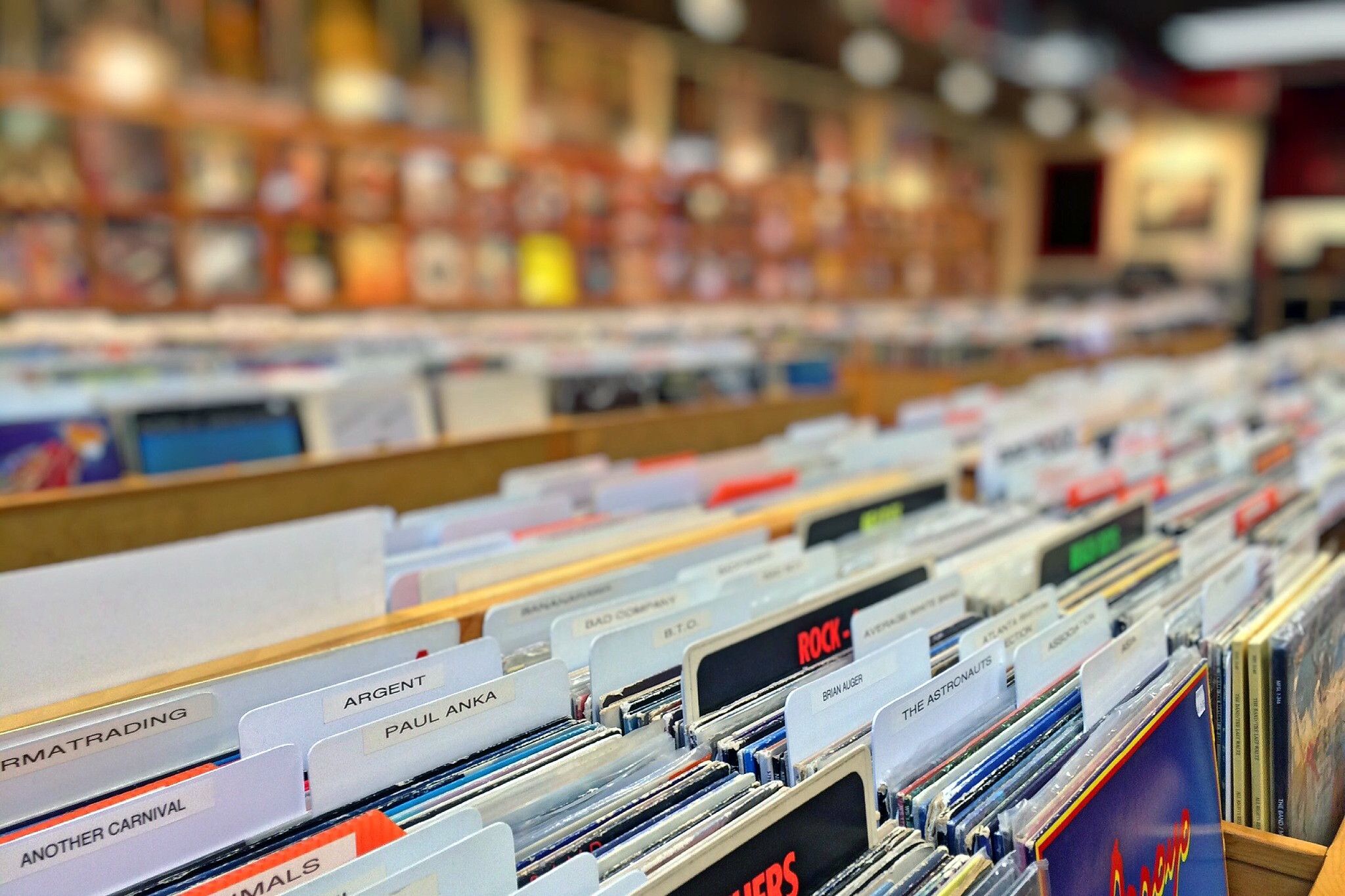 Racks of second hand vinyl records in an independent record shop, ready for digging