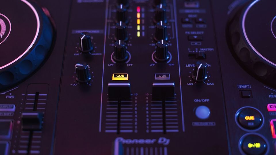 DJ hands on a Pioneer mixer preparing to record a set