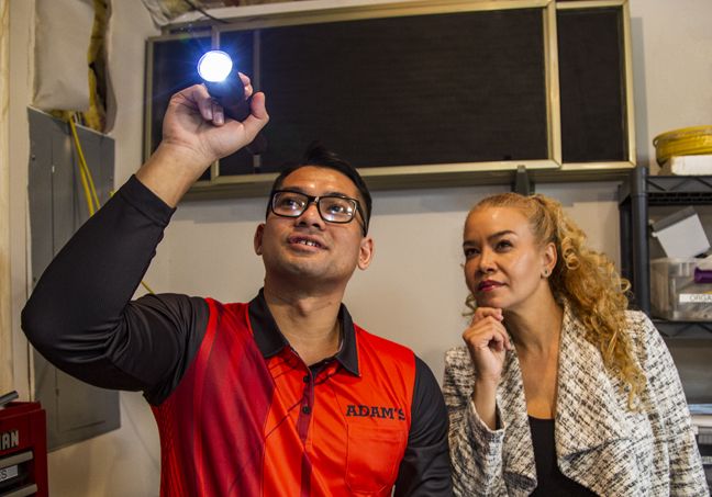 Pest control technician showing pest damage to a concerned homeowner.