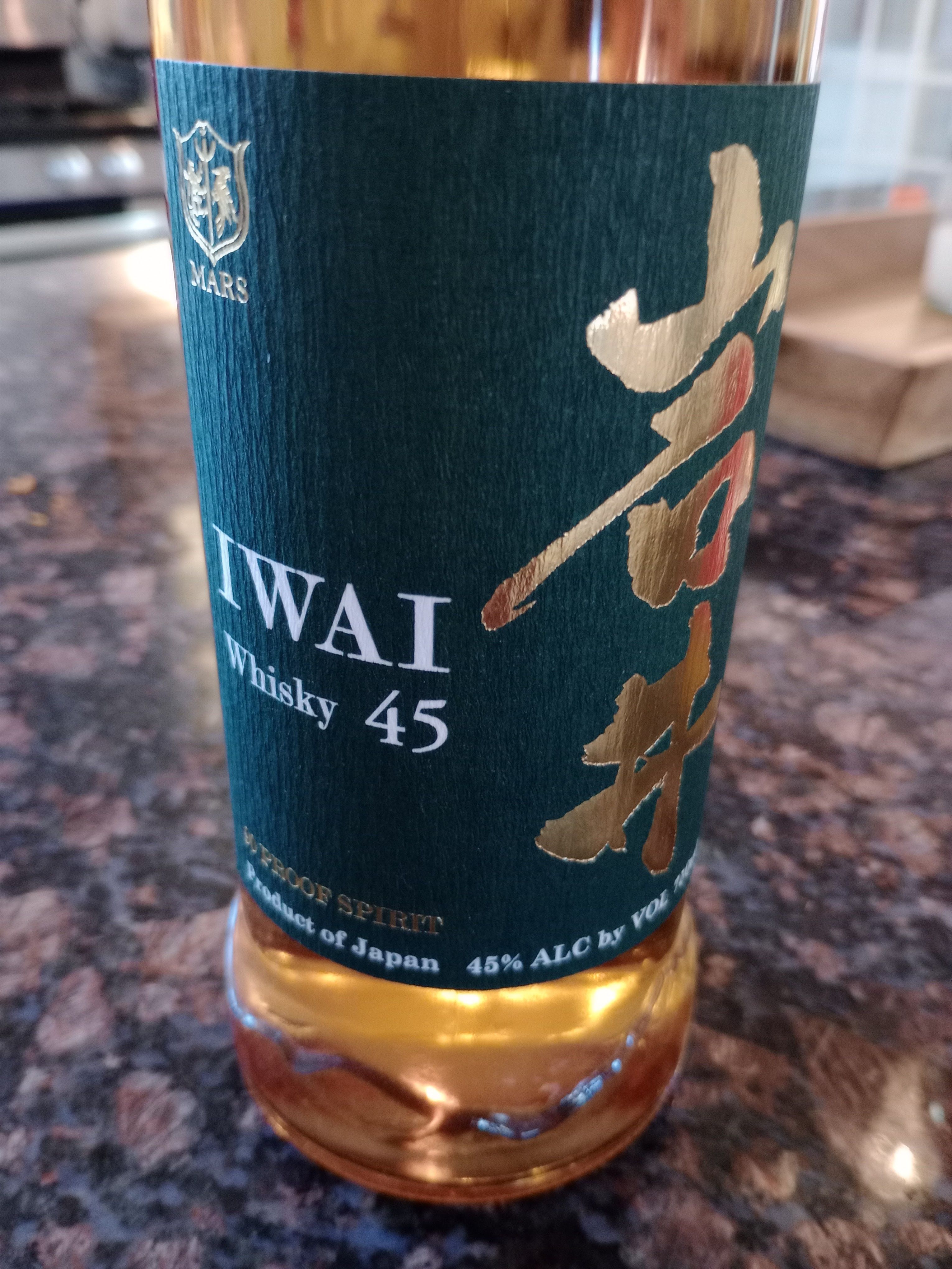 Close-up of a Mars Iwai 45 whisky bottle with its blue and gold label.