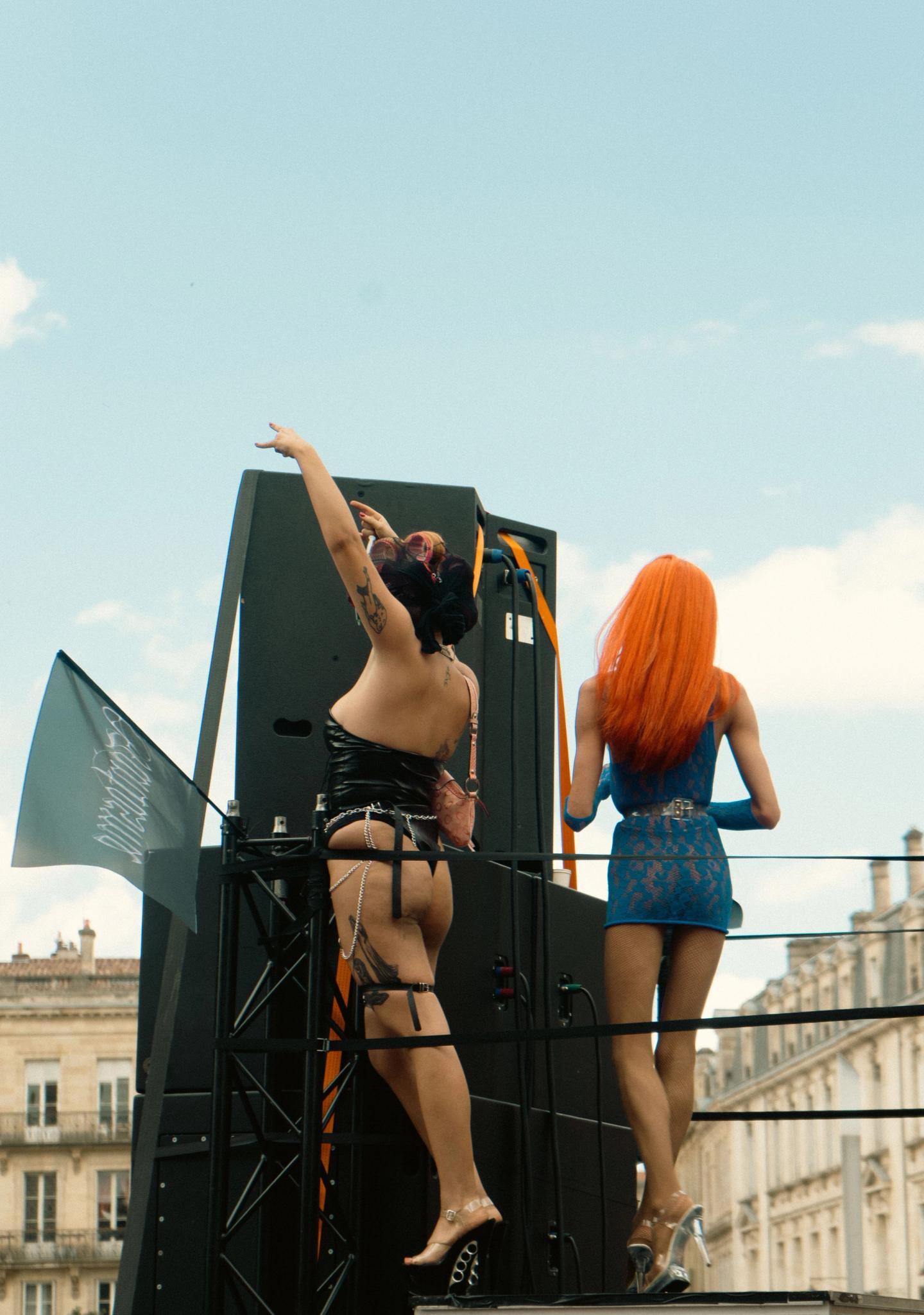 Two drag queens on a Pride float