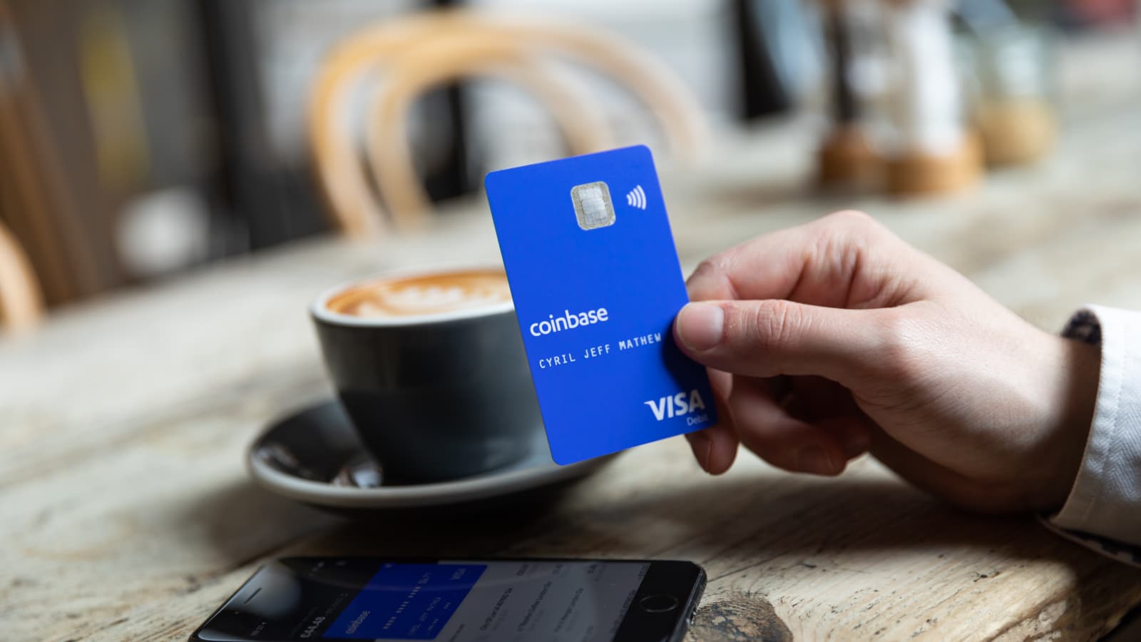 person presenting card - Best Crypto Credit Cards