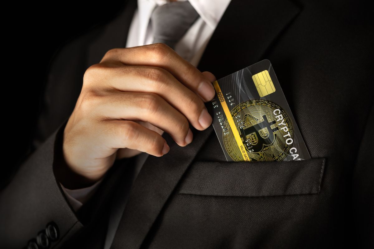 person putting card in pocket - Best Crypto Credit Cards
