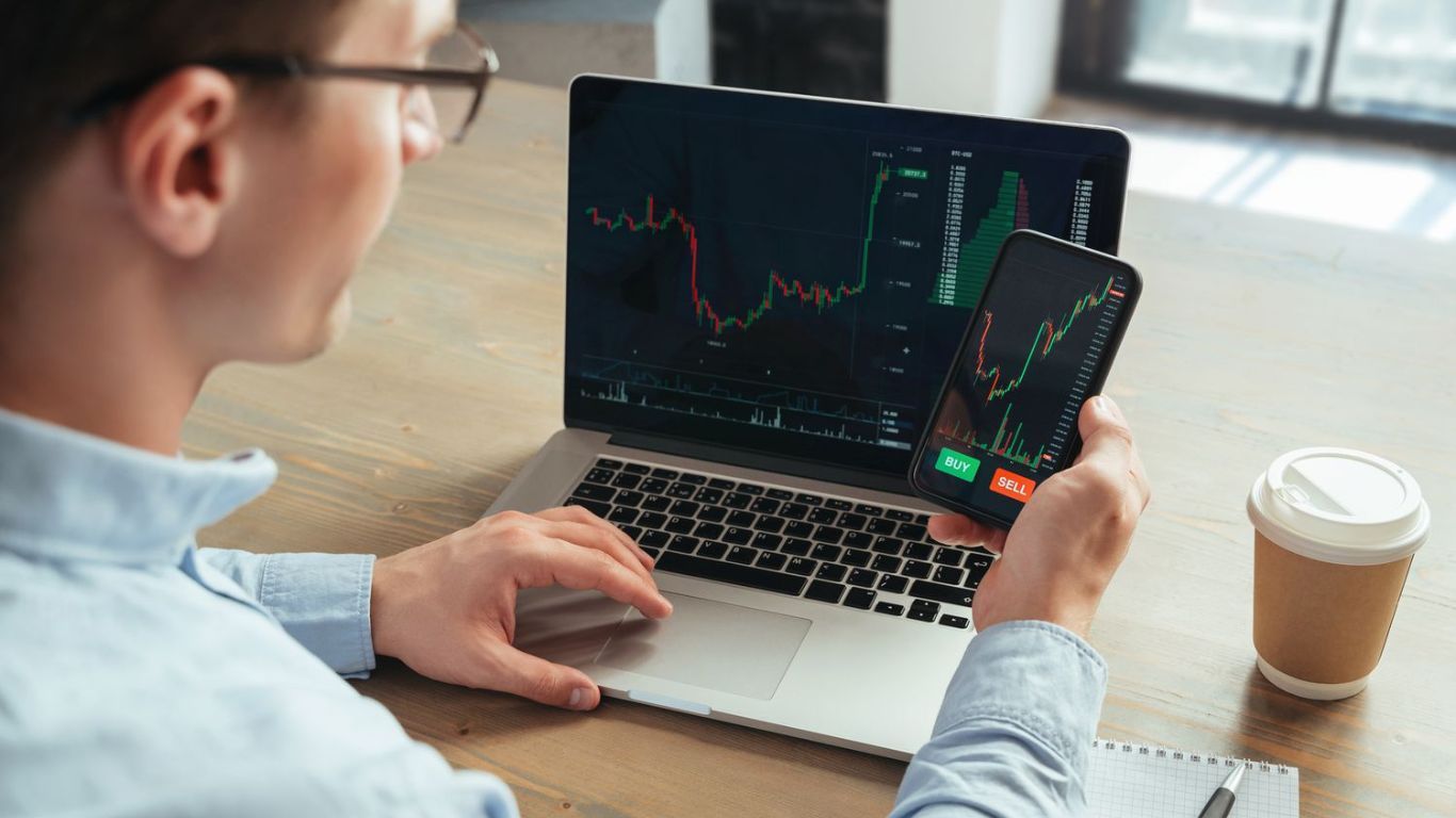 man focused on trades - Automated Crypto Trading Strategies