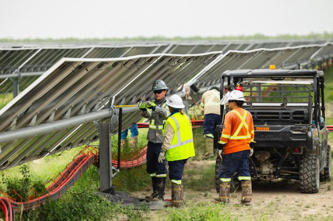 Solar construction crew at sunset on a utility-scale site