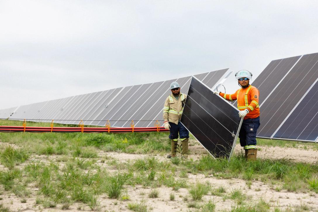 Electrician working on a utility-scale solar inverter station
