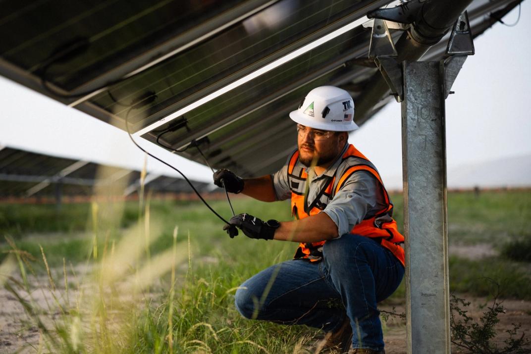 Solar module installer working on a panel array